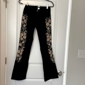 Black jeans with gold design down the side of both legs by Venus Size 2